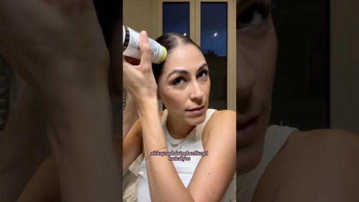 Slicked-back bun with postpartum bangs